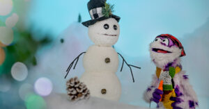 Murphy the monster puppet looking up at Mr. Shivers the snowman on the North Pole set for Sam and Murphy Christmas Sketch.