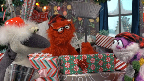GIF of Sam and Murphy I Spot Santa set showing Gordy the nervous pumpkin peeking through the North Pole window between decorated walls.