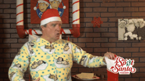 Marc Robert as Bernie yelping in pain as mousetraps snap onto his fingers in a 2015 I Spot Santa sketch — classic slapstick from family-friendly comedy writer and director Pasquale Murena.